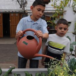Boys Watering Plants at Growhaus