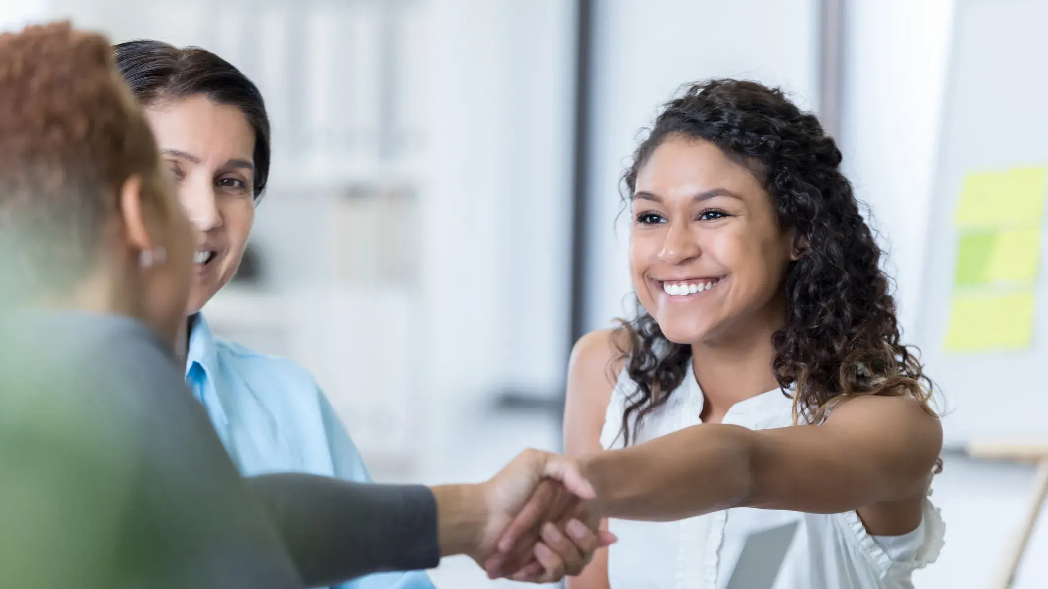 latino woman shaking hands in partnership