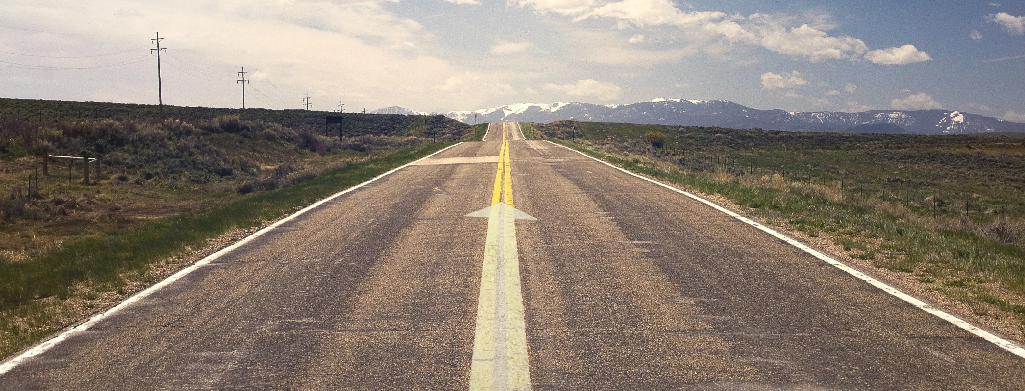 A road with an arrow pointing forward